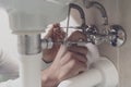 Plumber fixing a sink at home Royalty Free Stock Photo