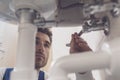 Plumber fixing a sink at home Royalty Free Stock Photo