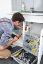 Plumber Fixing Sink In Kitchen Royalty Free Stock Photo