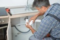 Plumber Fixing Sink Pipe In Kitchen Royalty Free Stock Photo