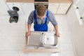 Plumber Fixing Stainless Steel Sink Royalty Free Stock Photo