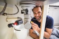 Plumber fixing under the sink Royalty Free Stock Photo