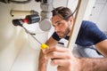 Plumber fixing under the sink Royalty Free Stock Photo