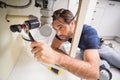 Plumber fixing under the sink Royalty Free Stock Photo