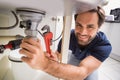 Plumber fixing under the sink Royalty Free Stock Photo