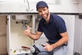 Plumber fixing under the sink Royalty Free Stock Photo