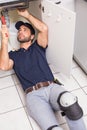 Plumber fixing under the sink