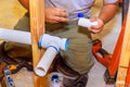 Plumber glues plastic pipes system new house construction Royalty Free Stock Photo