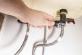 Hand installs valve by adjustable wrench on boiler