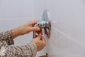 Plumber hands fixing shower mixer on modern water tap