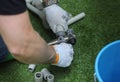 Plumber hands in gloves joining plastic pipes with the soldering iron for PVC pipes Royalty Free Stock Photo