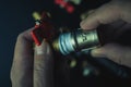 Plumber hands screwing nut of pipe over plumbing tools background. Concept of repair and technical assistance. Close up shot.