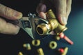 Plumber hands screwing nut of pipe over plumbing tools background. Concept of repair and technical assistance. Close up shot.