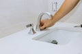 Plumber hands at work in a bathroom, plumbing repair service the faucet of a sink Royalty Free Stock Photo