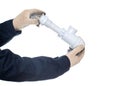 Plumber holding a drain siphon on a white background, isolate, close-up. Equipment Royalty Free Stock Photo