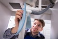 Plumber Holding Napkin To Stop Sink Pipe Leakage