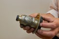 A man holds a broken pump part,the plumber holds a broken rotor of a circulation water pump in his hands