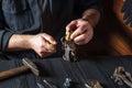 Plumber inserts the brass fittings into a vise. Close-up of a foreman hand while working in a workshop