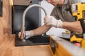 Plumber Installing Kitchen Sink and a Faucet Royalty Free Stock Photo