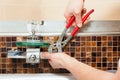 Plumber installing a mixer tap in a bathroom Royalty Free Stock Photo