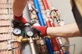 Plumber installing water equipment - meter, filter and pressure reducer