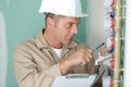 Plumber installing pressure meter for house heating system Royalty Free Stock Photo