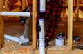 Plumber installing primer and glue PVC pipe at construction home