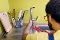 Plumber installing, repairing water tap in kitchen Royalty Free Stock Photo