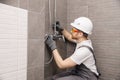 Plumber installing water taps shower stall, work in bathroom Royalty Free Stock Photo