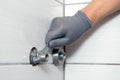 A plumber installs eccentrics to install a faucet in a bathroom Royalty Free Stock Photo