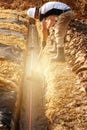 Plumber installs a reinforced orange sewer pipe during site maintenance. Royalty Free Stock Photo