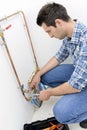Plumber making adjustments to heating system
