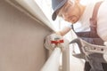 Plumber man is blocking repairs radiators of heating battery in apartment tap