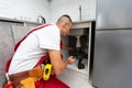 Plumber man fix repair service wraps fluoroplastic sealing material tape around faucet hose. Concept install plumbing in