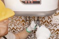 Plumber man installing boiler water heater in bathroom Royalty Free Stock Photo