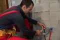 Plumber man with tools. Plumbing and renovation. Royalty Free Stock Photo