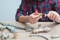 Plumber measures the size of fitting before connecting water pipe. Plumber connects fittings while repairing equipment. Close-up Royalty Free Stock Photo