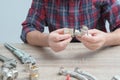 Plumber measures the size of fitting before connecting water pipe. Plumber connects fittings while repairing equipment. Close-up Royalty Free Stock Photo