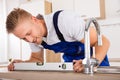 Plumber Measuring Level Of A Sink Royalty Free Stock Photo