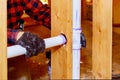 A plumber in plastic sewer pipe into putting glue on a pvc pipe Royalty Free Stock Photo