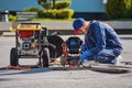 Plumber prepares to fix the problem in the sewer with portable camera for pipe inspection and other plumbing work Royalty Free Stock Photo