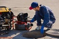 Plumber prepares to fix the problem in the sewer with portable camera for pipe inspection and other plumbing work Royalty Free Stock Photo