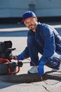 Plumber prepares to fix the problem in the sewer with portable camera for pipe inspection and other plumbing work Royalty Free Stock Photo