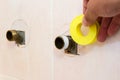 The plumber puts Teflon seam FUM tape on the thread before installing the faucet tap. Close up Royalty Free Stock Photo
