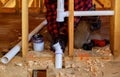 Plumber putting glue on a PVC drain pipe, closeup