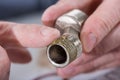 Plumber putting sealing paste on a thread