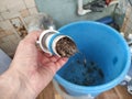 Plumber removes the blockage in the pipe in the kotchen