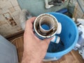 Plumber removes the blockage in the pipe in the kotchen