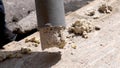A plumber removes solid deposits from grease and debris.