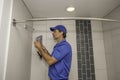 Plumber removing a showerhead